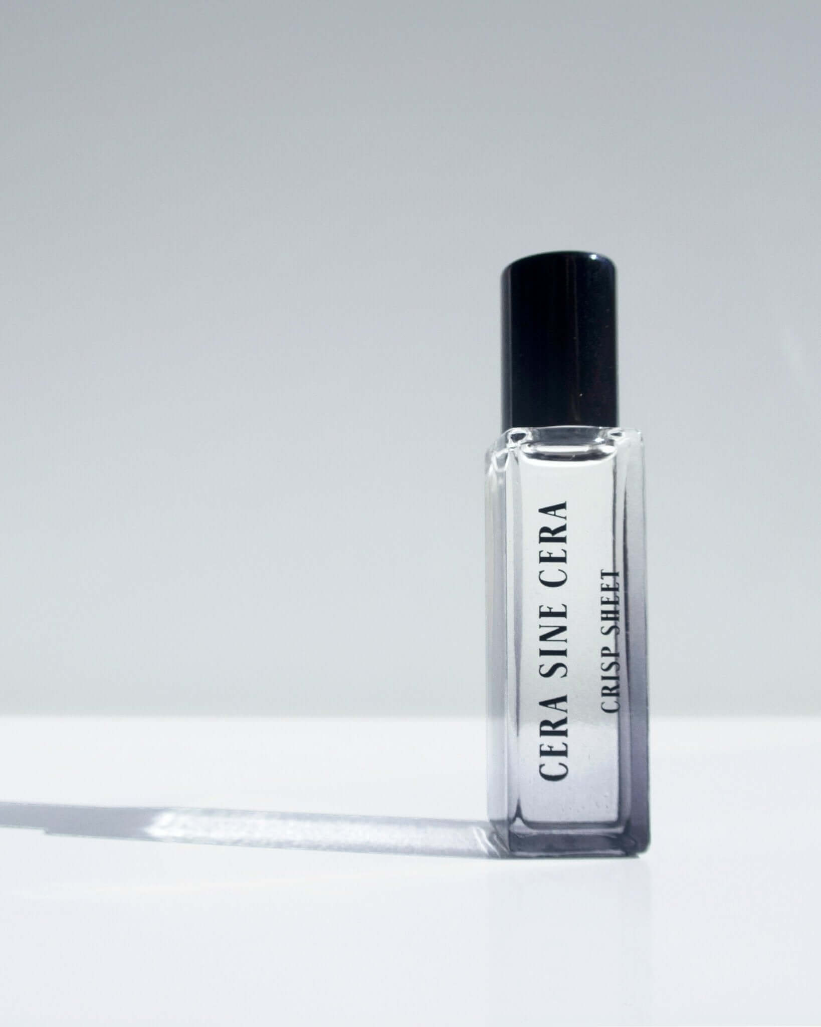 Crisp Sheet Perfume Oil - 10ml roll-on by Cera Sine Cera, fragrance notes of pink pepper, sandalwood, and ylang ylang. Scent of fresh, woody, and spicy. Non-alcoholic, non-toxic, Vegan, and cruelty free.